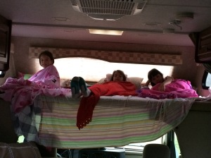 All 3 girls wanted to sleep in the space over the cab.
